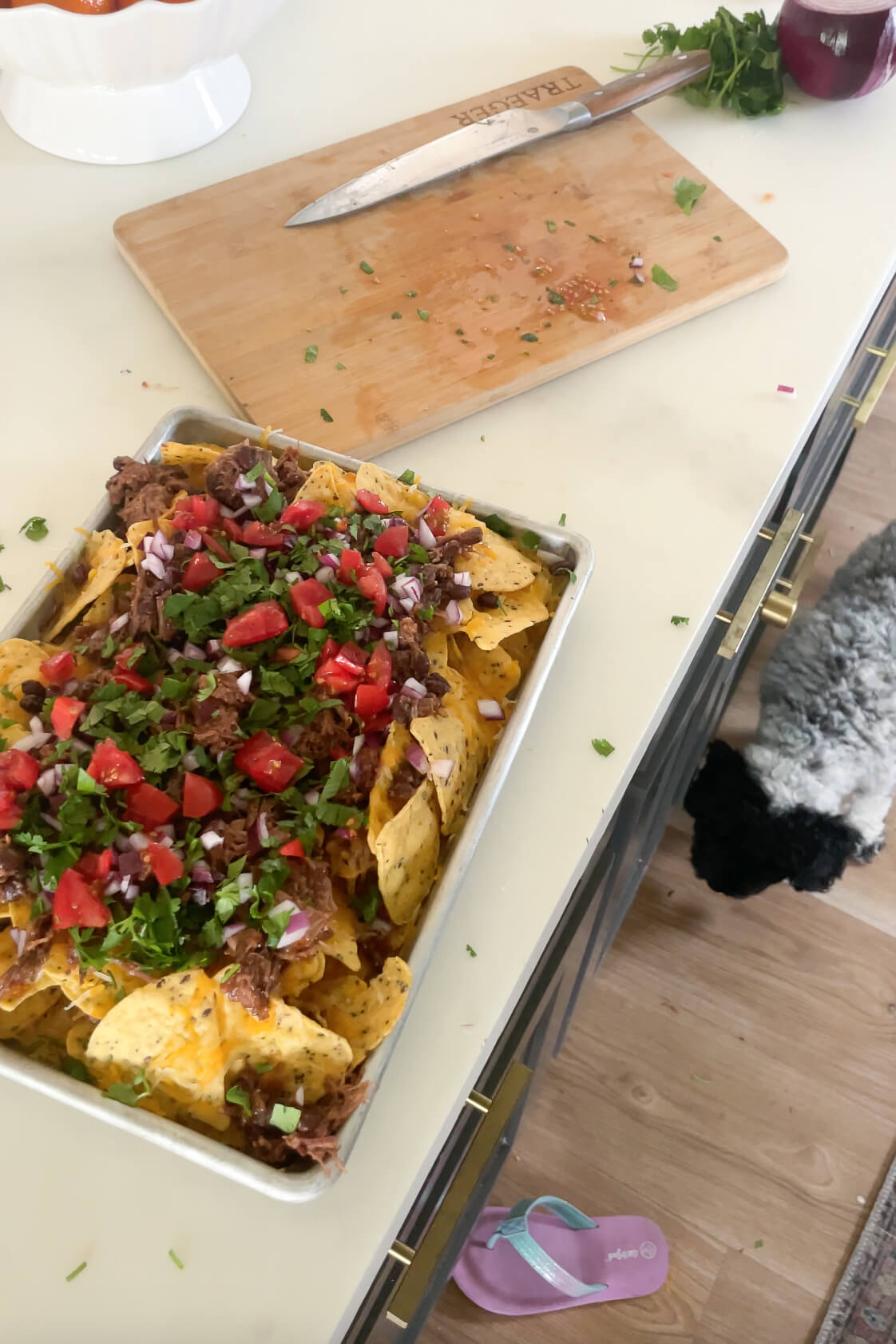 Adding the fresh toppings to the top of my oven nachos. 